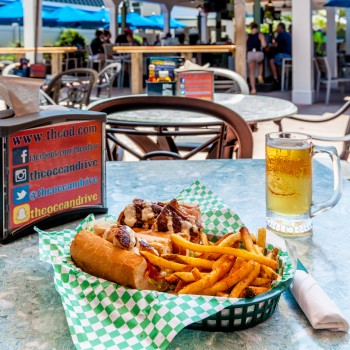 Chicken Sandwich in a basket with French Fries and a beer